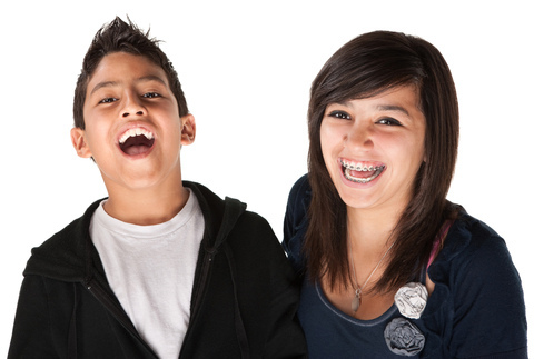 Two kids with orthodontics laughing